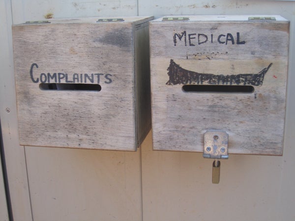 Unlocked complaints box next to locked medical request box, Curtin IDC